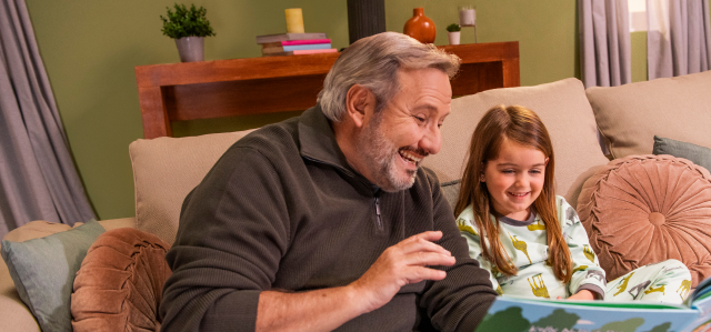 Hypothetical male with high LDL-C reading a book to his granddaughter