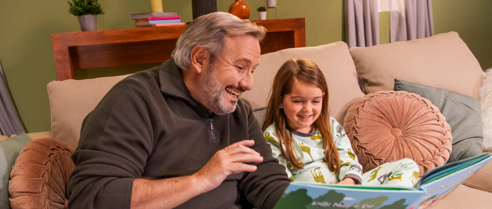 Hypothetical male with high ldl-c reading a book to his granddaughter